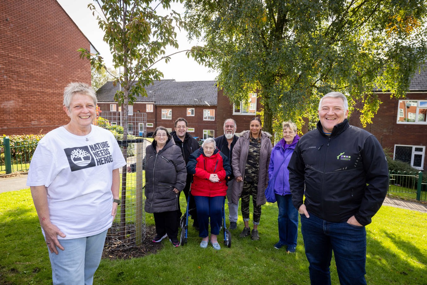OL1-Oldham community group pictured in Coldhurst neighbourhood with tree and FCHO Head of Neighbourhood Care to promote the Tree Guardians project