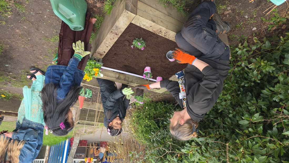 Netty Southward Helping Pupils Plant The Flowers