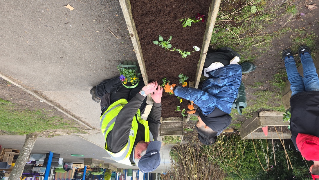 Mark Atkinson Assisting Reception Pupils With The Planting